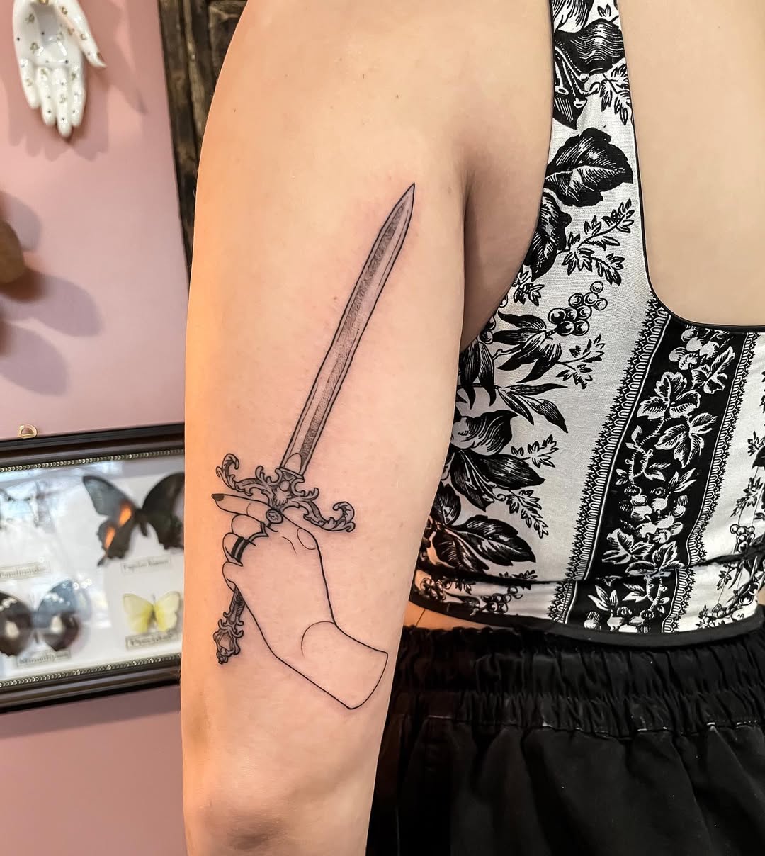 Elegant dagger tattoo showcasing strength and artistry