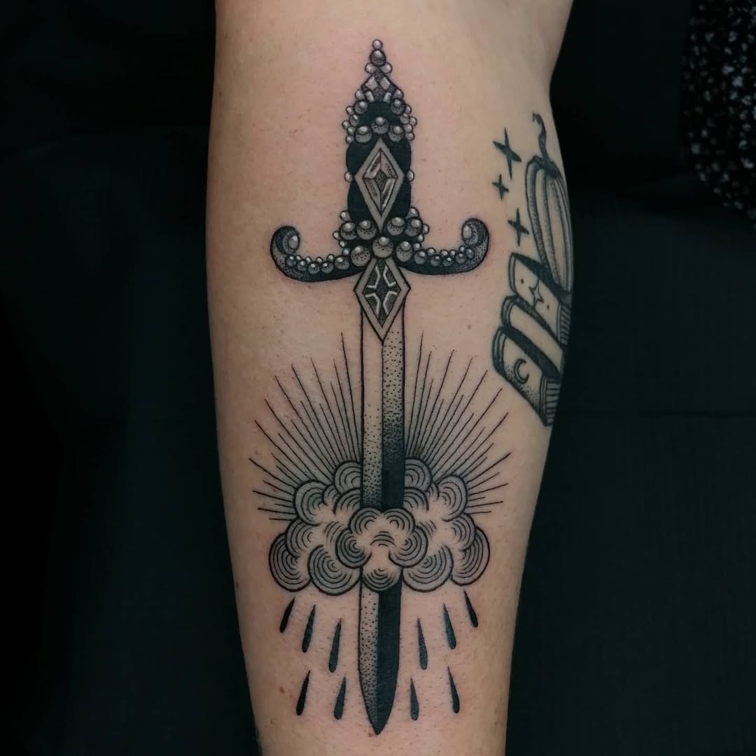 Intricate dagger tattoo with cloud details