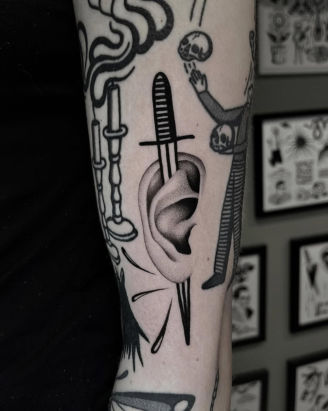 Intricate dagger tattoo featuring an ear motif