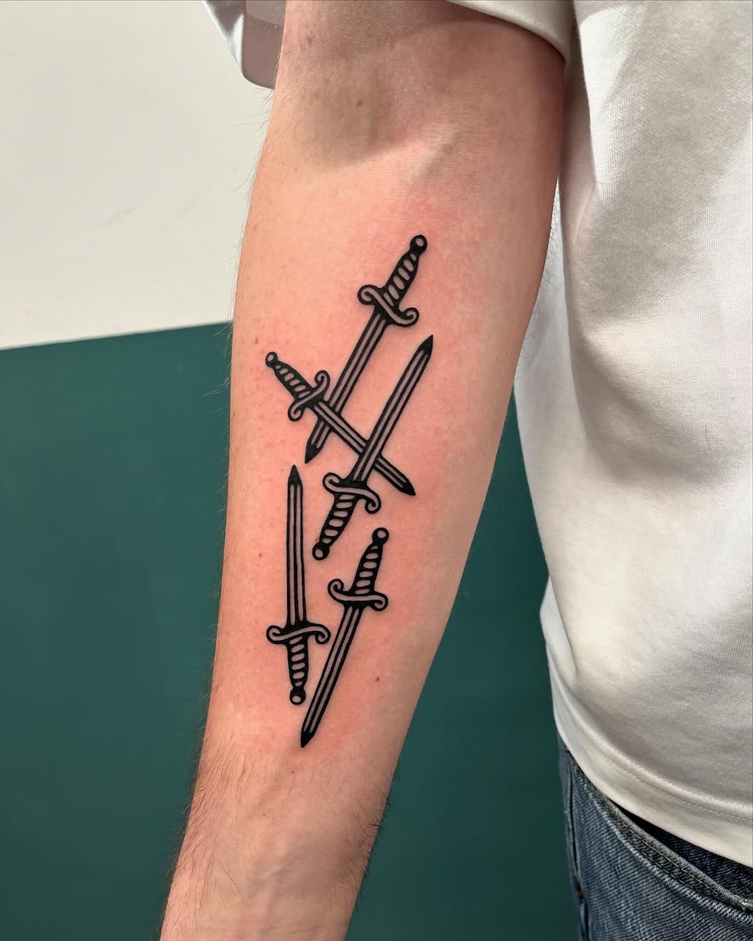 Intricate dagger tattoos with bold black ink