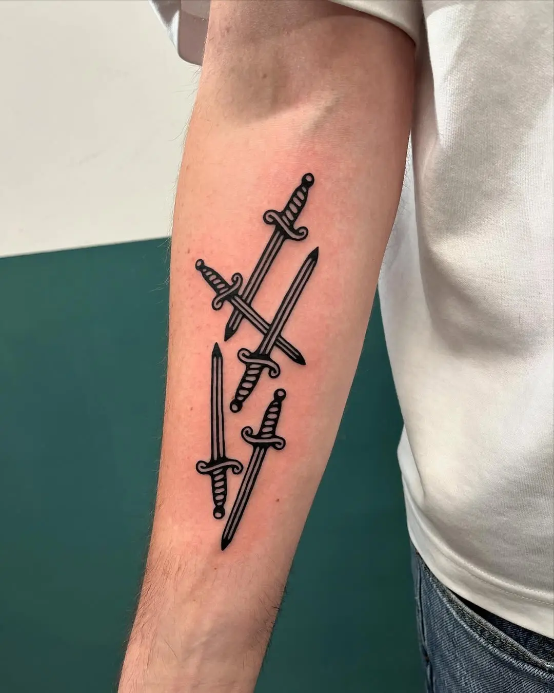 Intricate dagger tattoos with bold black ink
