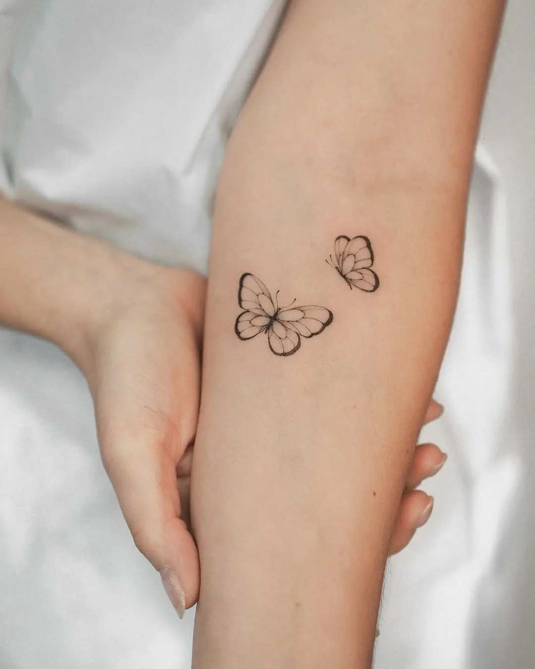 Elegant and minimalistic butterfly tattoo design