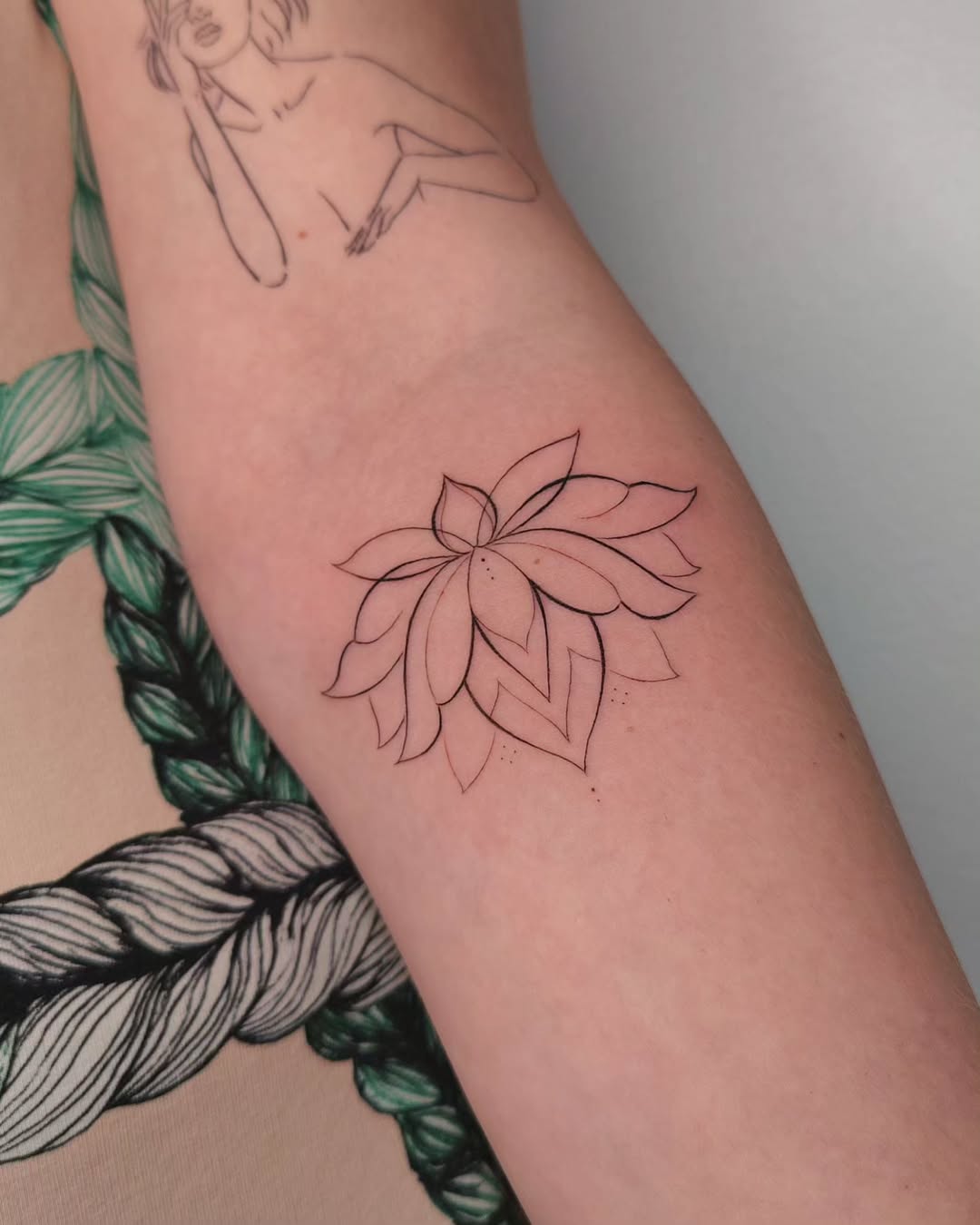 Elegant minimalist lotus tattoo design