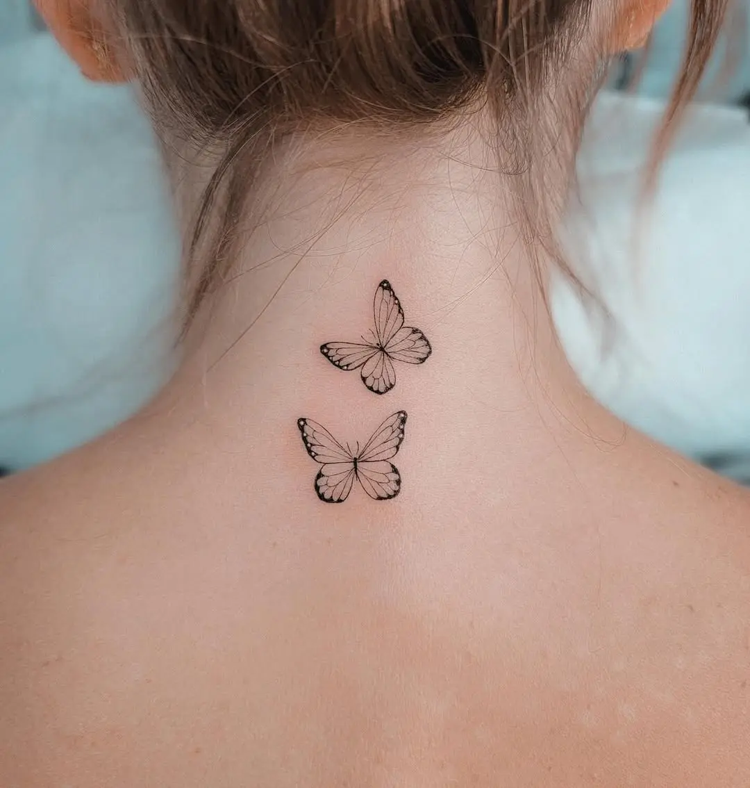 Delicate butterfly tattoos on a graceful neck