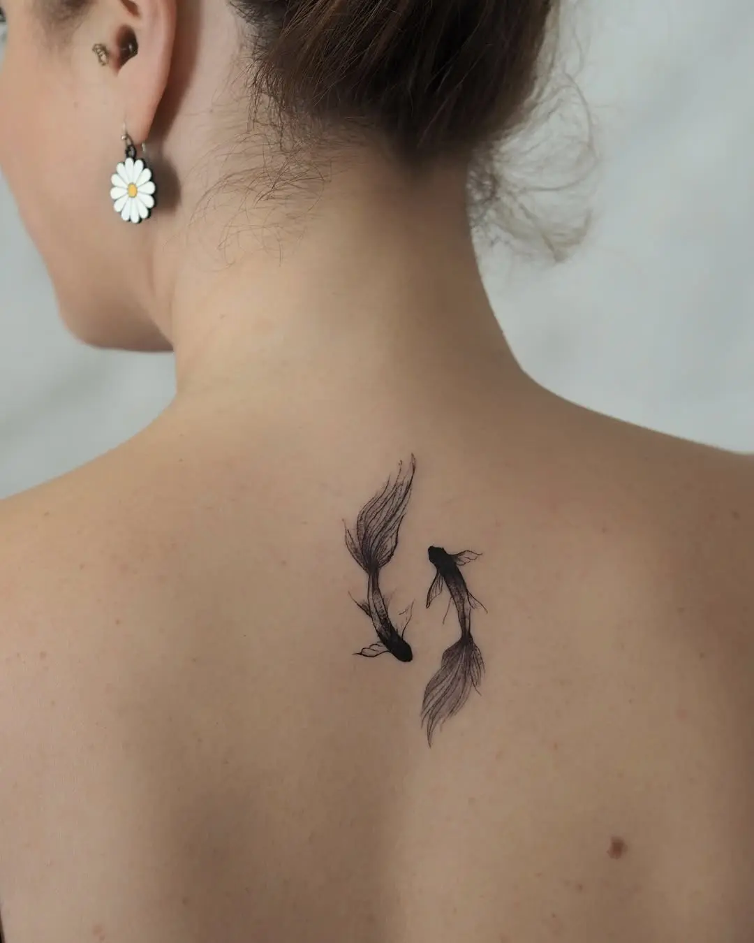 Elegant koi fish tattoo on the back