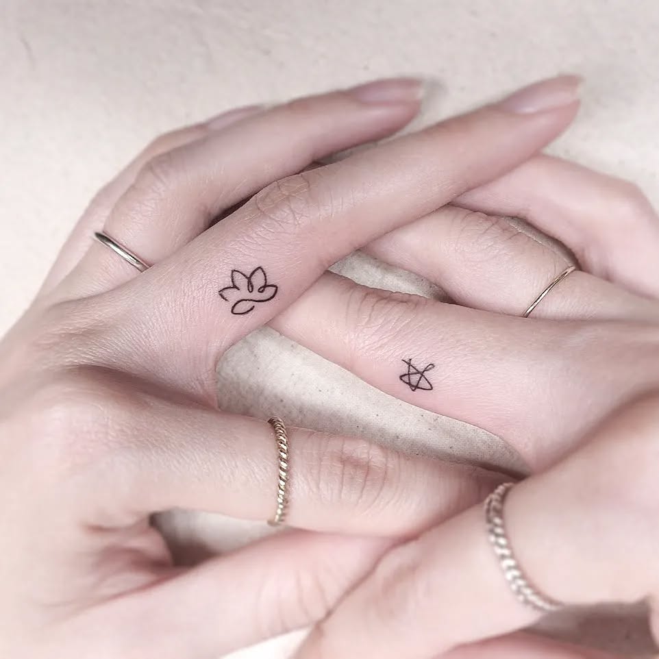 Elegant lotus tattoo on delicate fingers