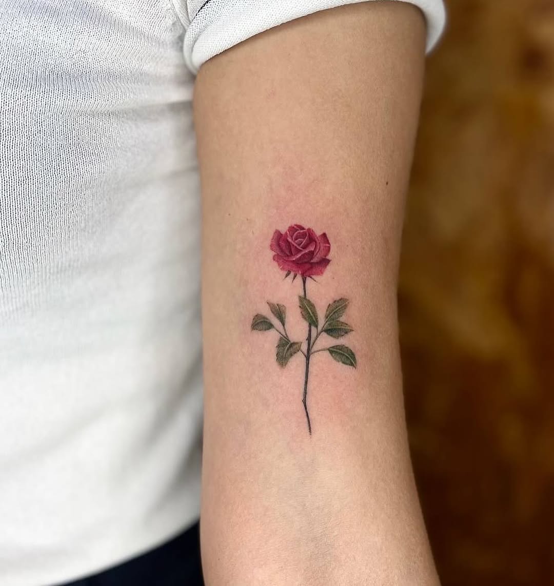 A delicate rose tattoo symbolizing beauty and love