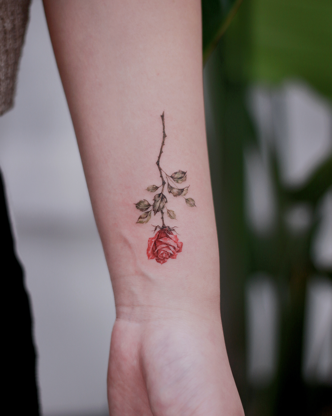 Elegant rose tattoo with subtle earthy tones