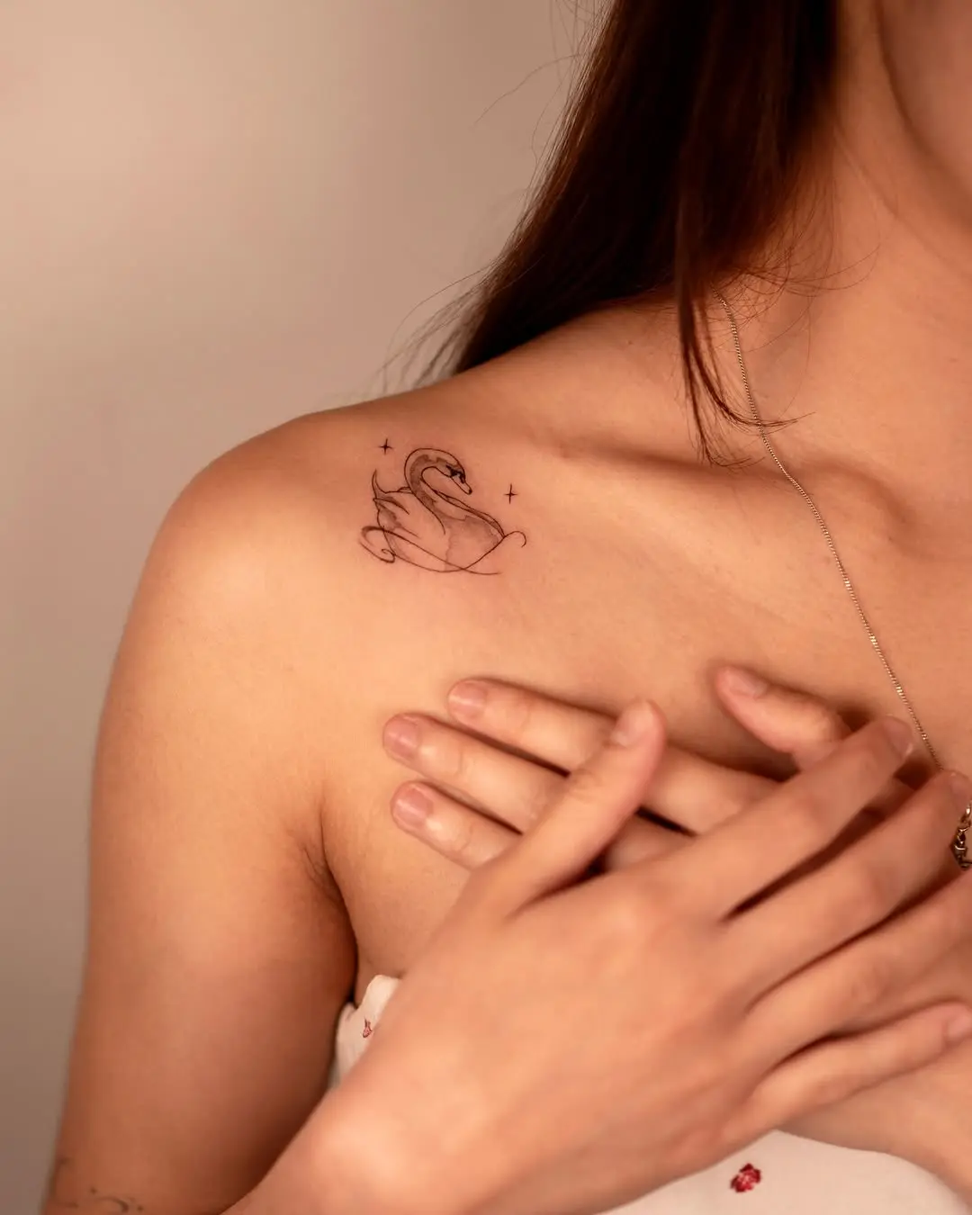 Elegant swan tattoo on a woman's shoulder