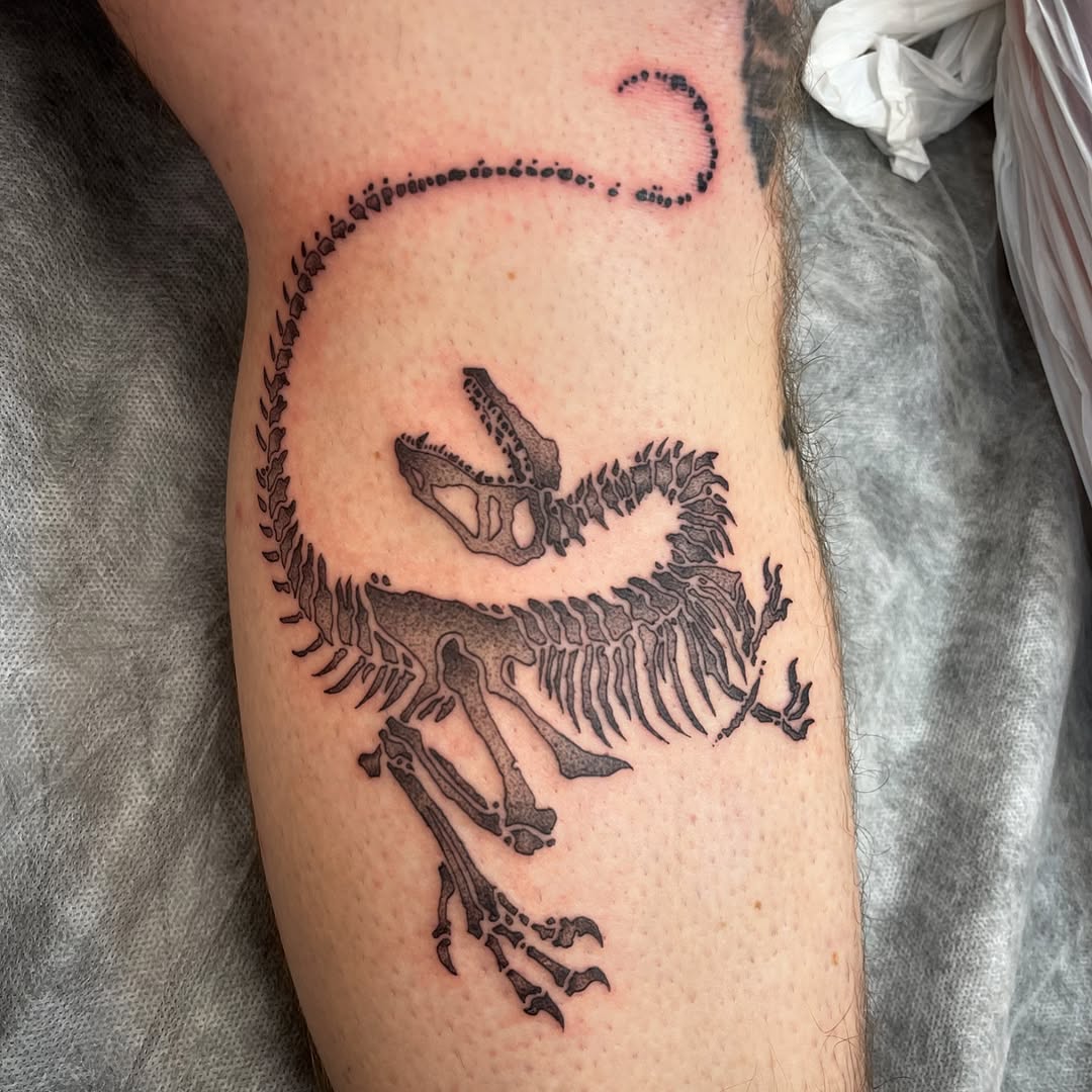 Intricate dinosaur skeleton tattoo design