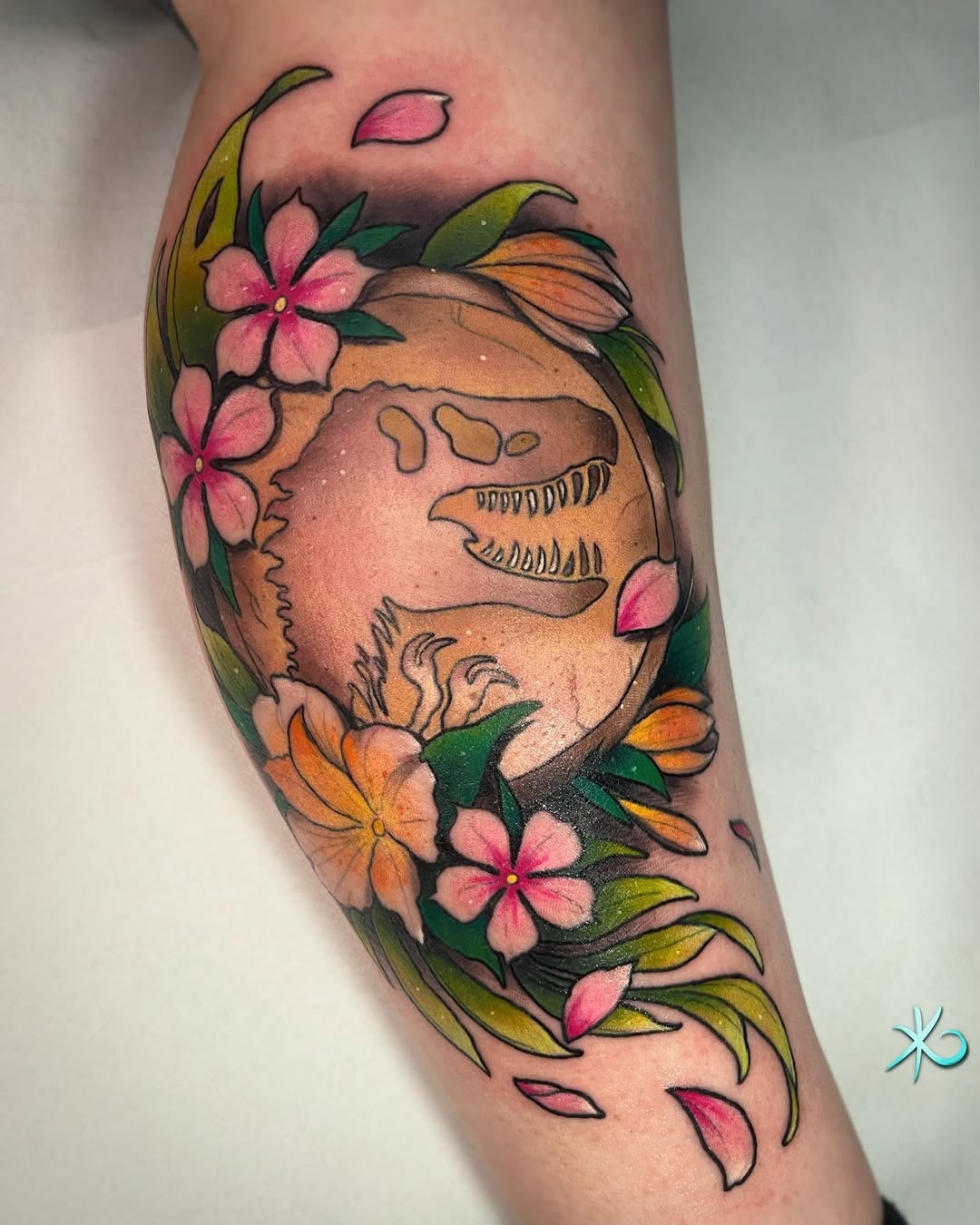 Vibrant dinosaur tattoo framed by blooming flowers