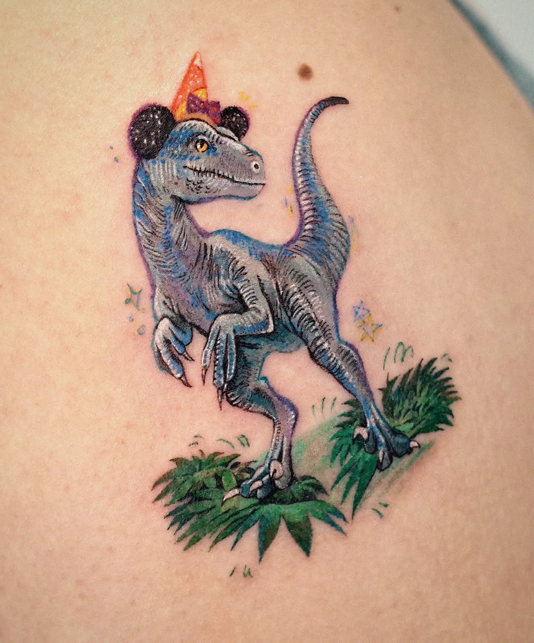 Festive raptor tattoo with party vibes