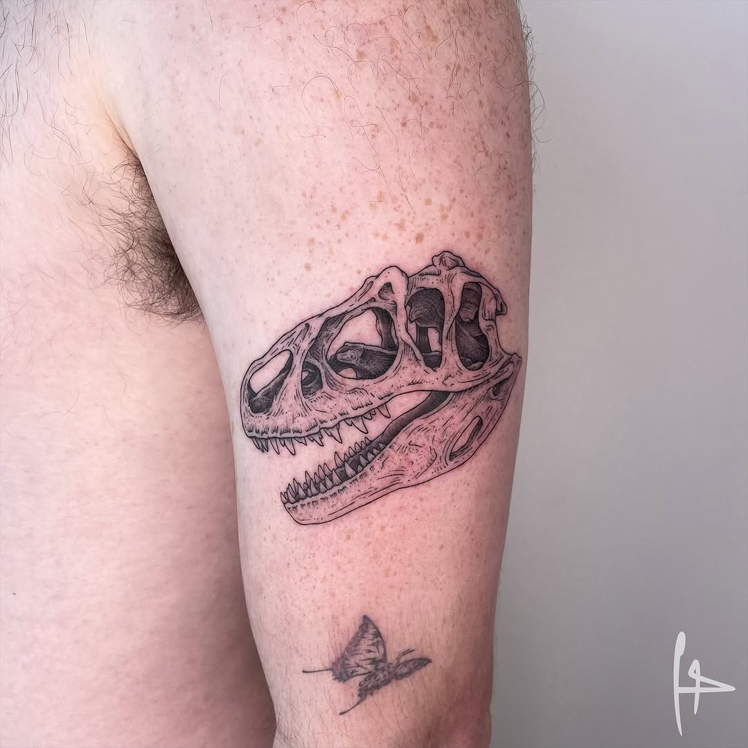 Intricate dinosaur skull tattoo on arm