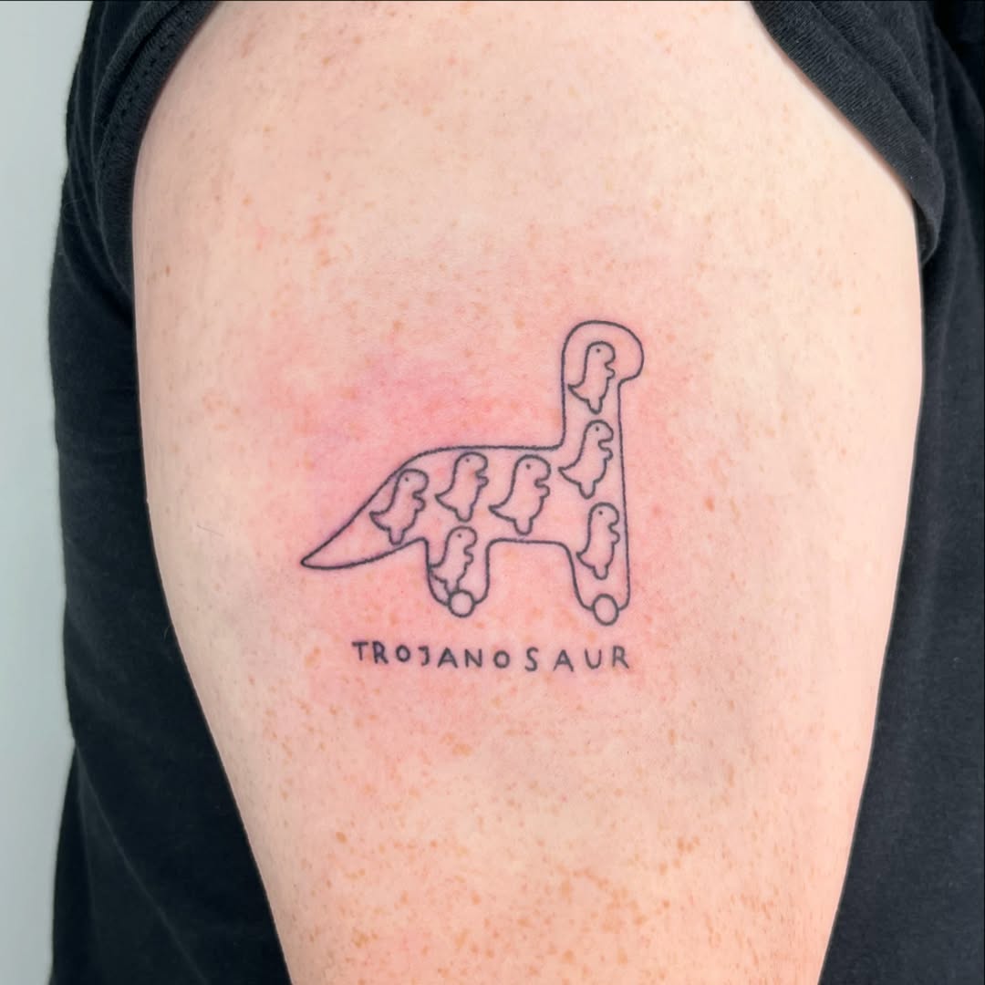 Playful Trojan dinosaur tattoo for fun vibes