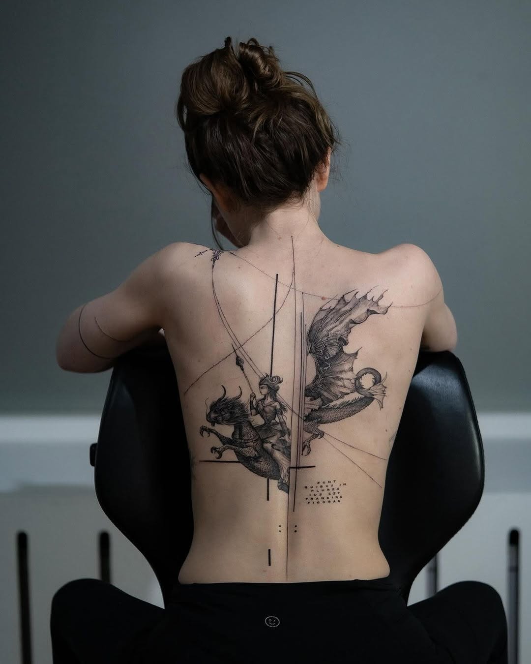 Dramatic back tattoo featuring a mythical dragon