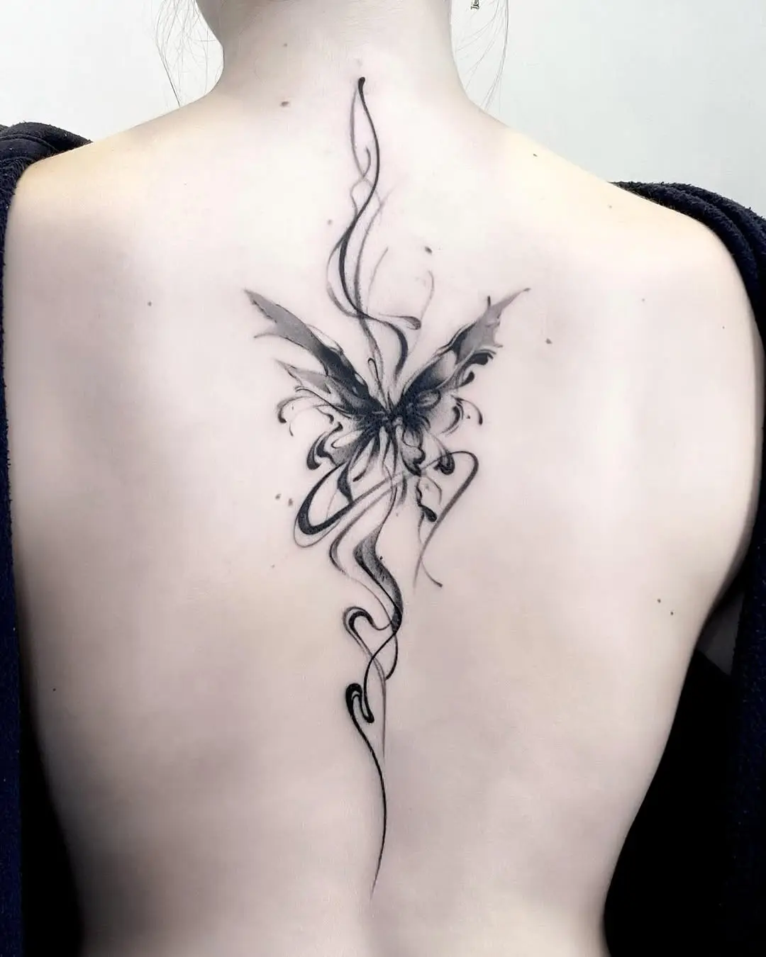 Elegant butterfly tattoo featuring intricate black details