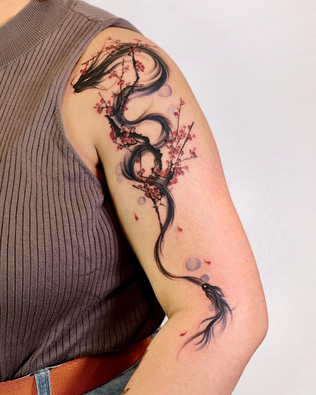 Elegant dragon and cherry blossom sleeve tattoo