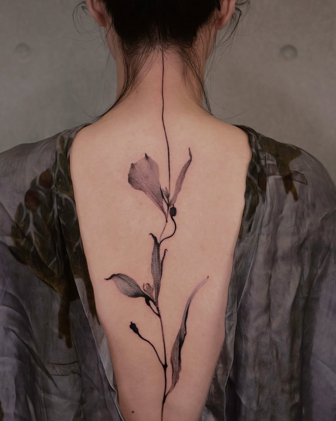 Elegant floral back tattoo for feminine vibes