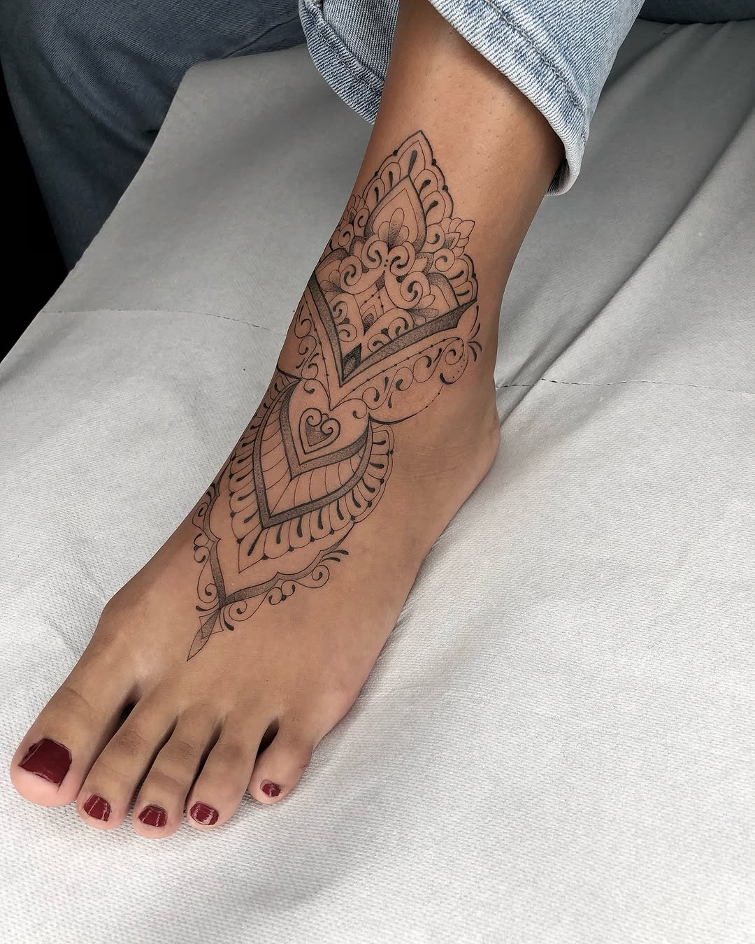 Intricate geometric foot tattoo design on display