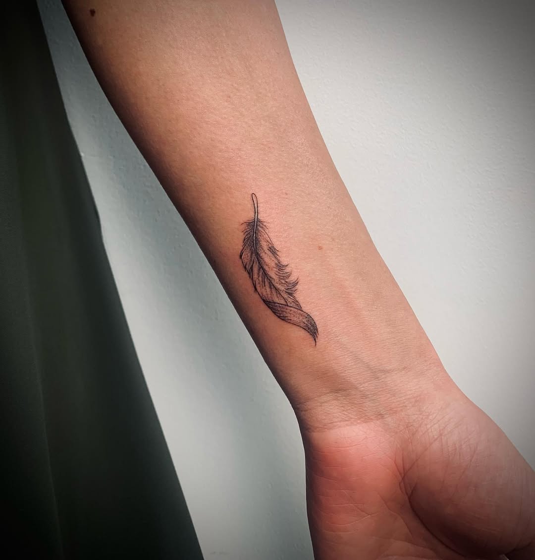 Delicate feather tattoo for minimalistic appeal