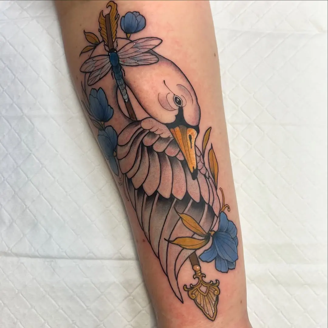 Elegant swan tattoo with floral accents