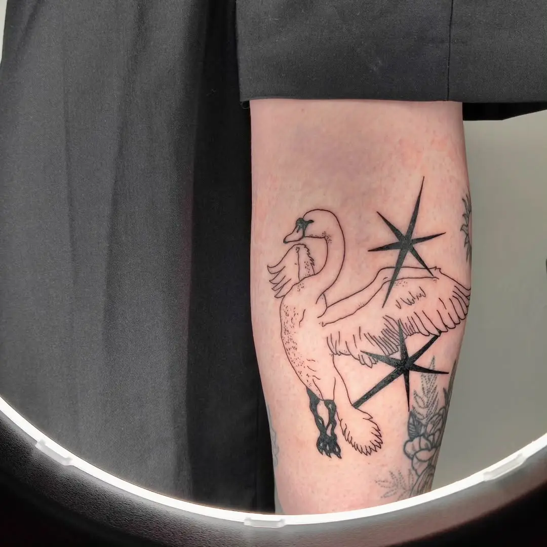 Elegant swan tattoo with striking star details