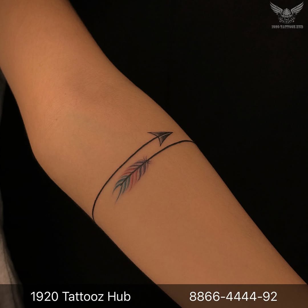 Elegant minimalist feather and arrow tattoo design