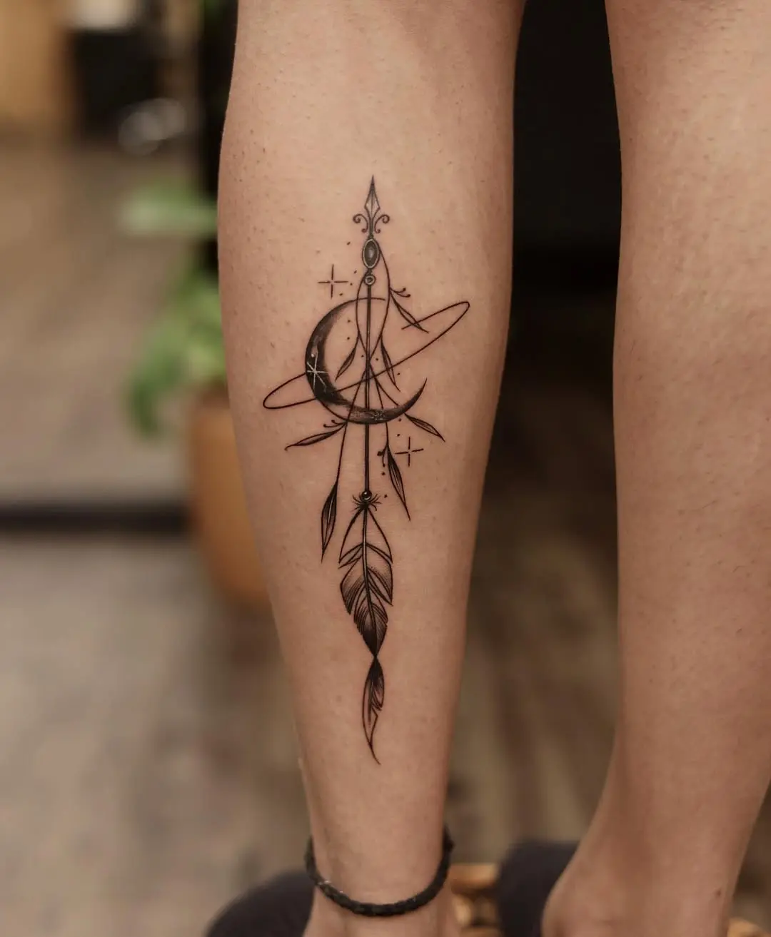 Stylish feather and moon tattoo design