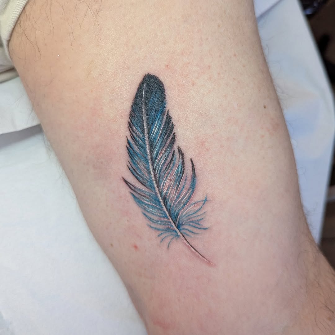 Elegant blue and black feather tattoo design