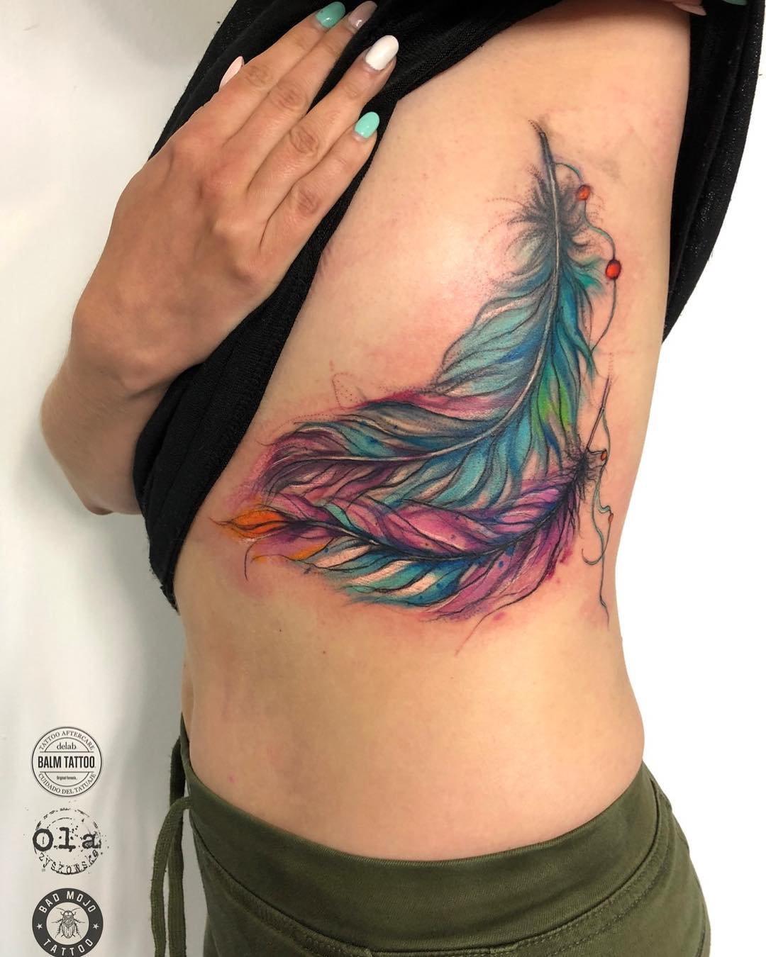 Vibrant feather tattoo showcasing colorful artistry