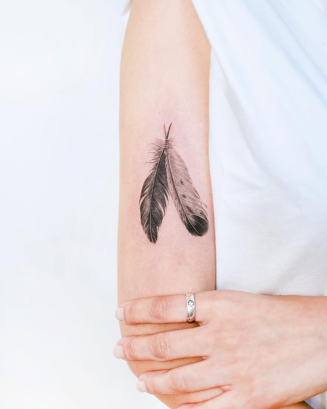 Elegant feather tattoo showcasing intricate details.