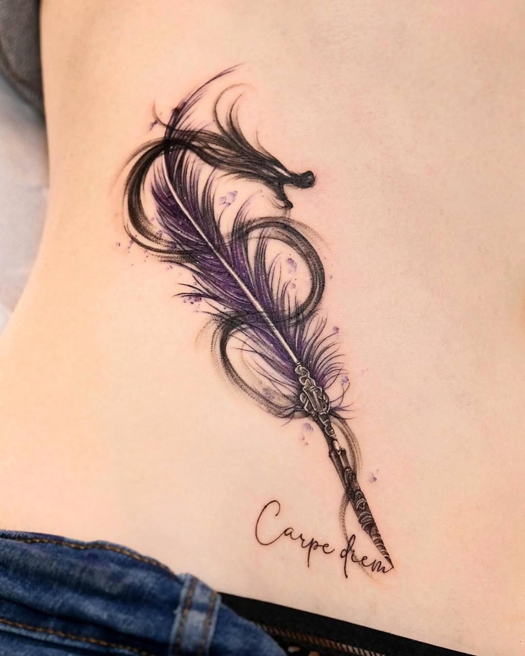 Elegant feather tattoo with inspirational script