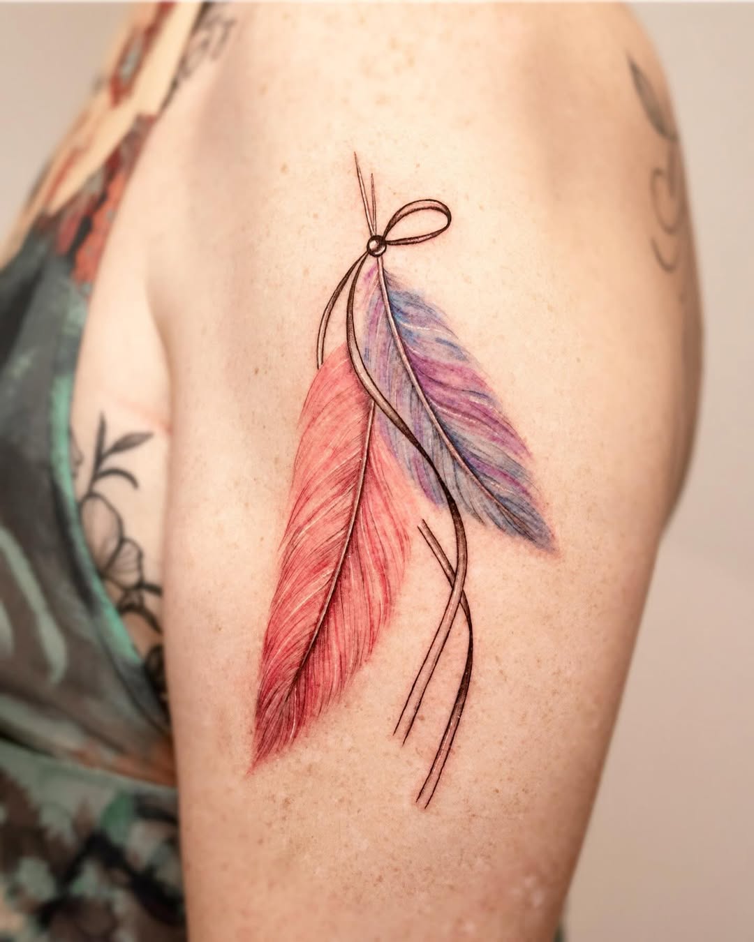 Colorful feather tattoo with elegant details