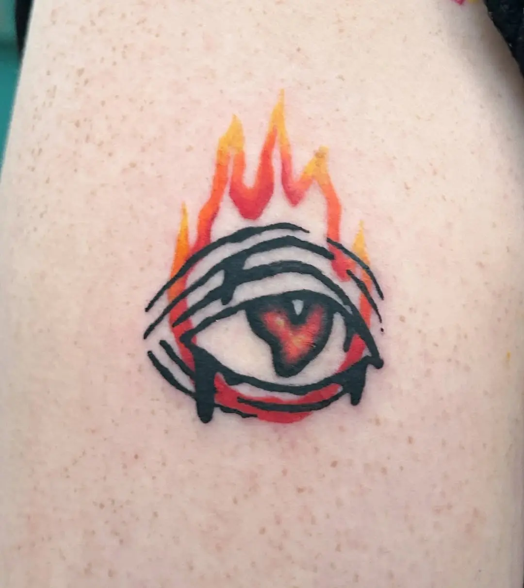 Unique eye tattoo with fiery flames encircling it
