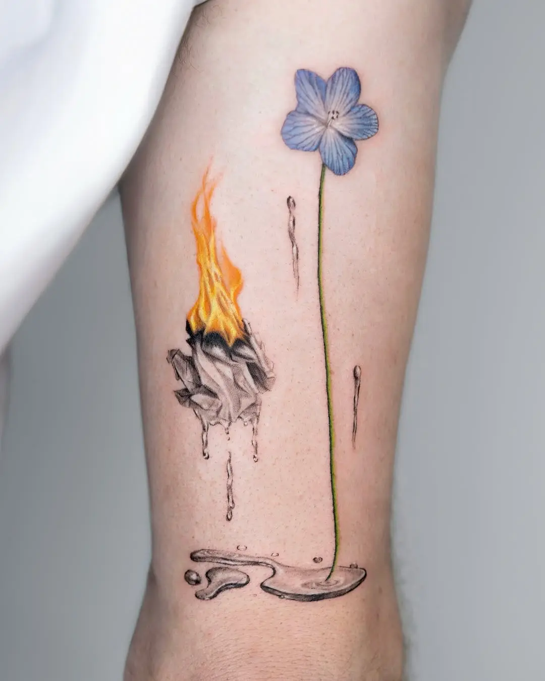 Intricate fusion of fire and floral tattoos