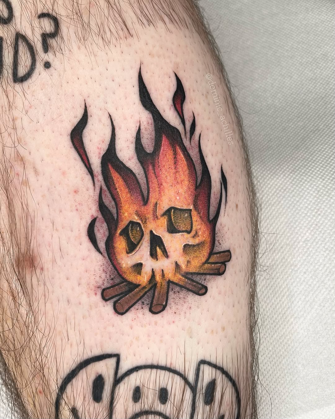 Vibrant fire skull tattoo on an arm