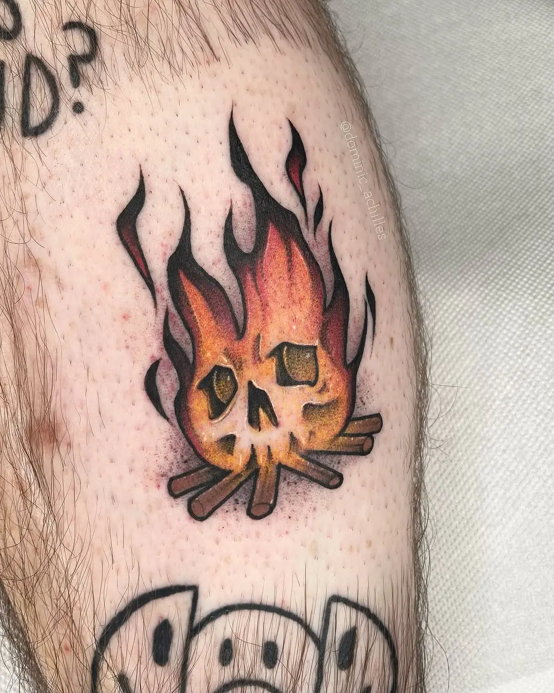 Vibrant fire skull tattoo on an arm