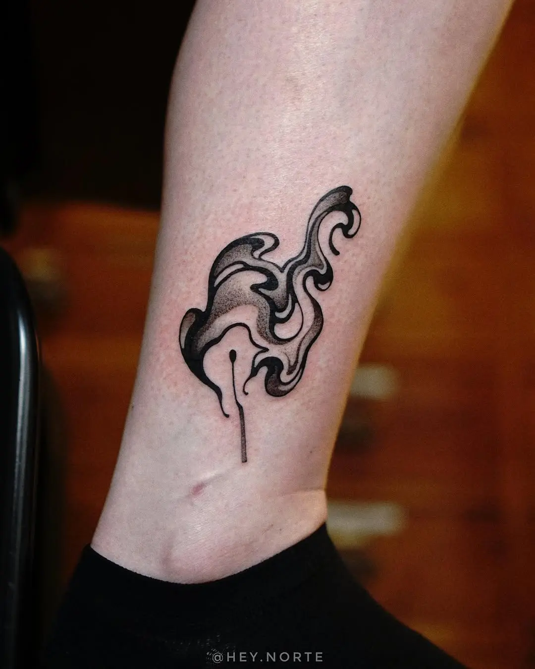 Stylish abstract fire tattoo on the leg