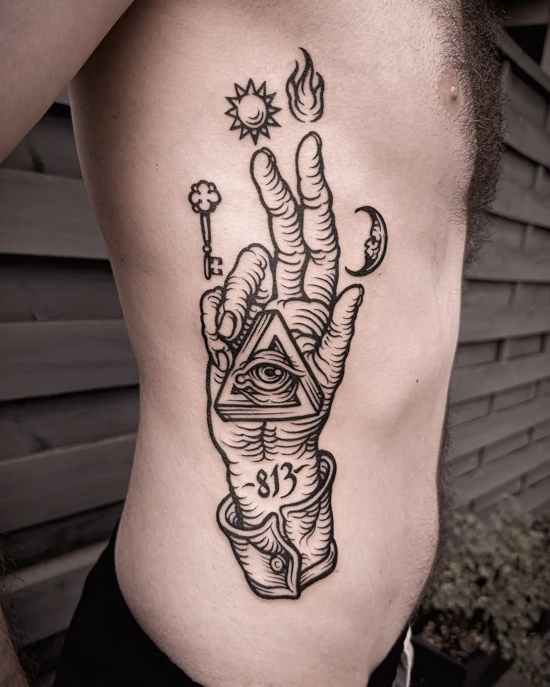 Intricate hand tattoo with celestial symbols