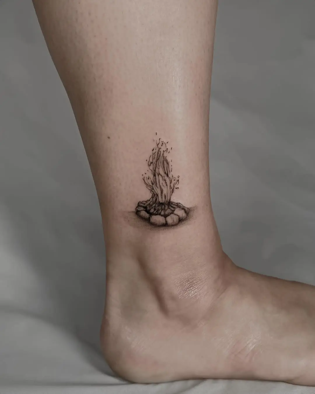 Realistic fire tattoo with earthy vibes