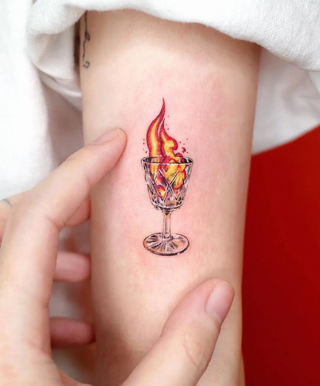 Colorful flame in a glass tattoo design