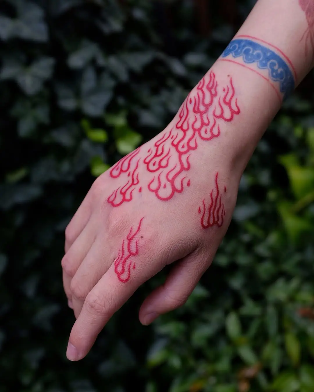Bold Red Flames Tattoo on Hand