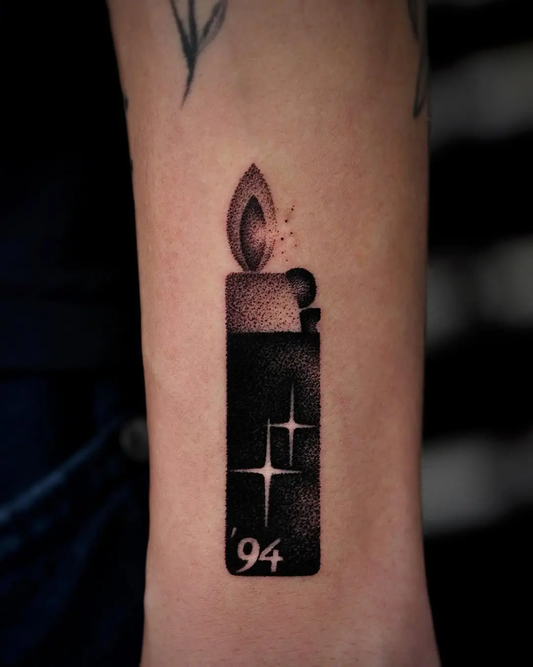 Sleek lighter tattoo with flame design