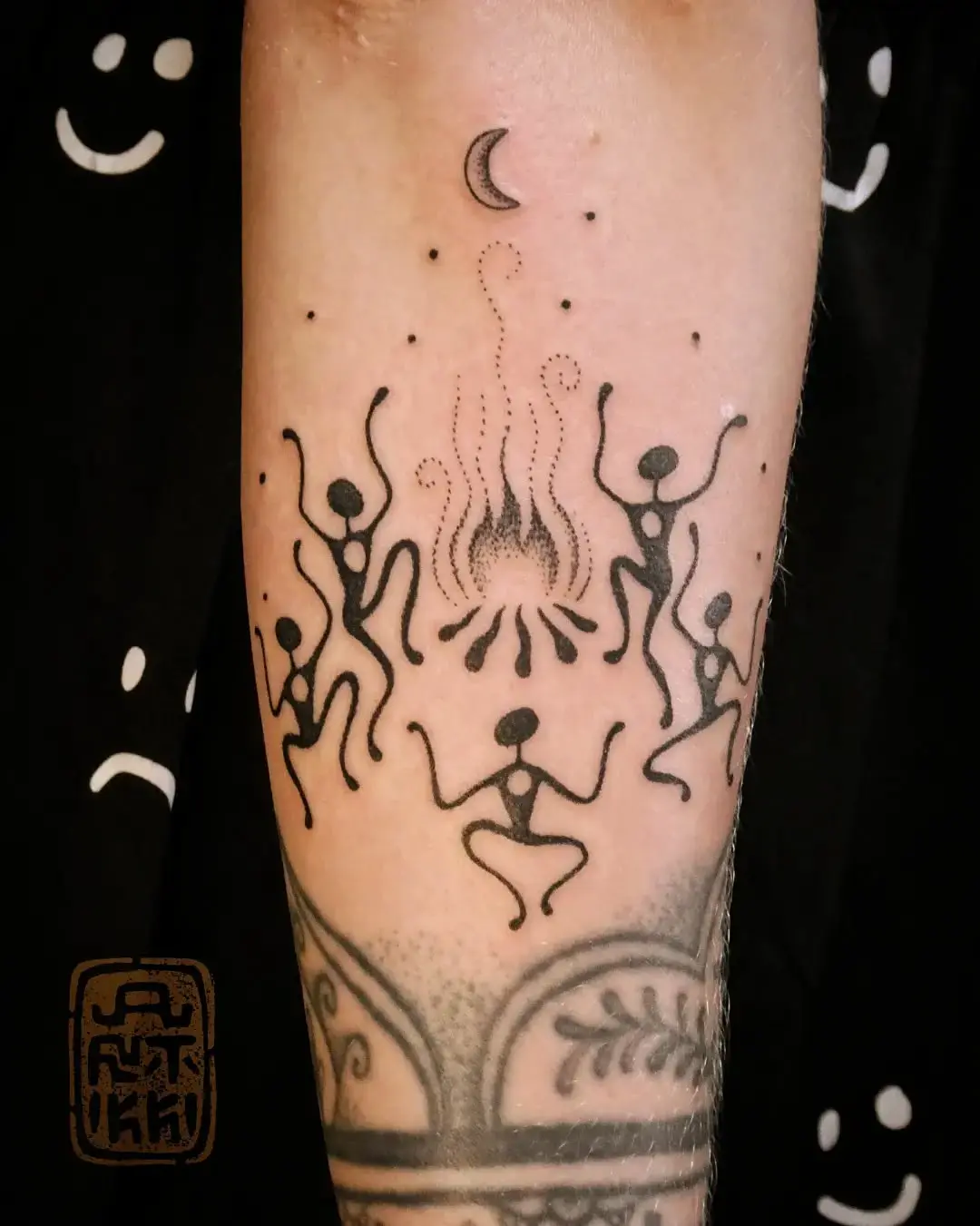 Whimsical dancing figures around a fire
