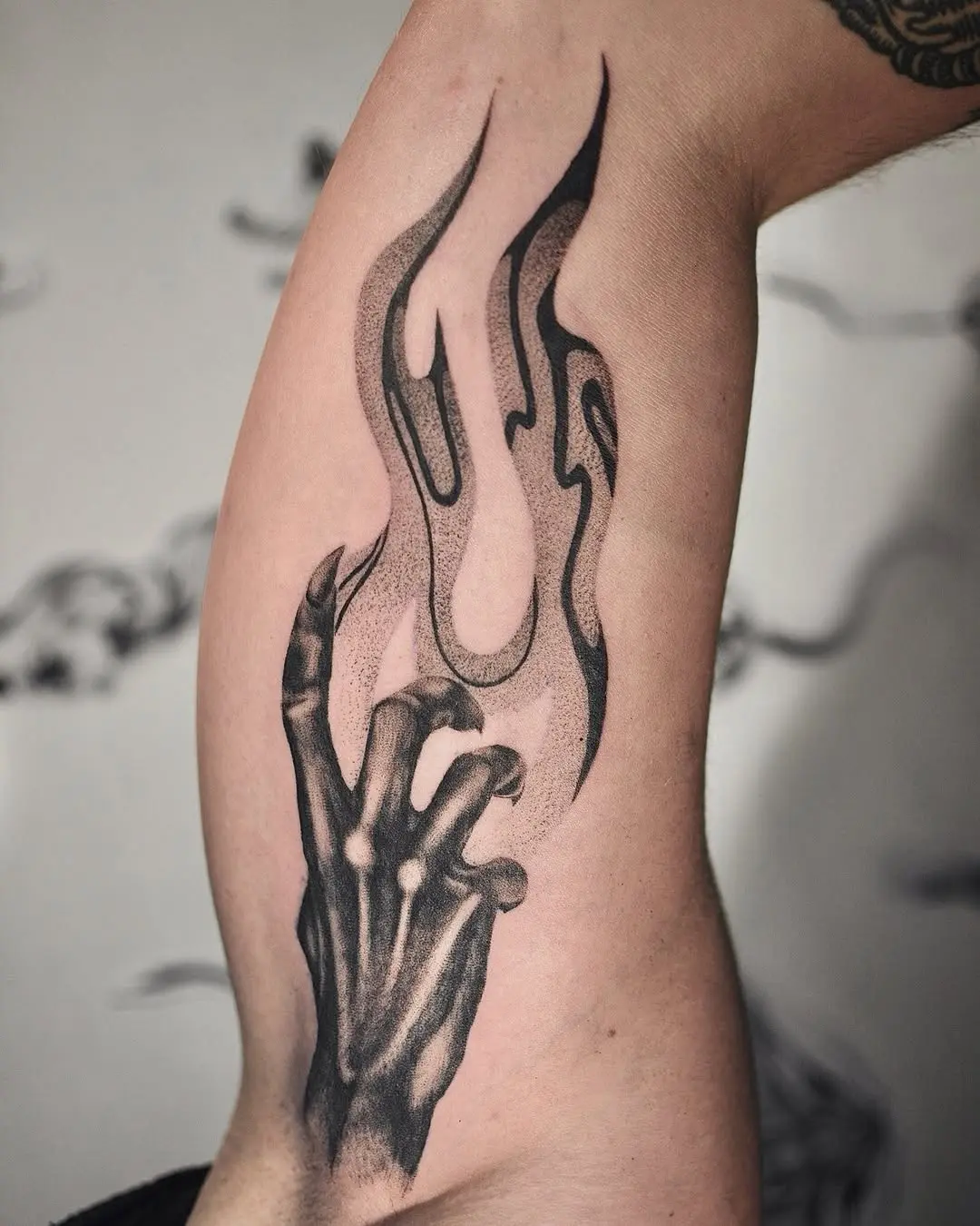 Intricate fire tattoo with skeletal hand design