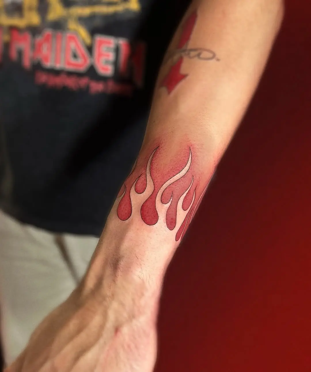 Stylish red flames tattoo on the arm