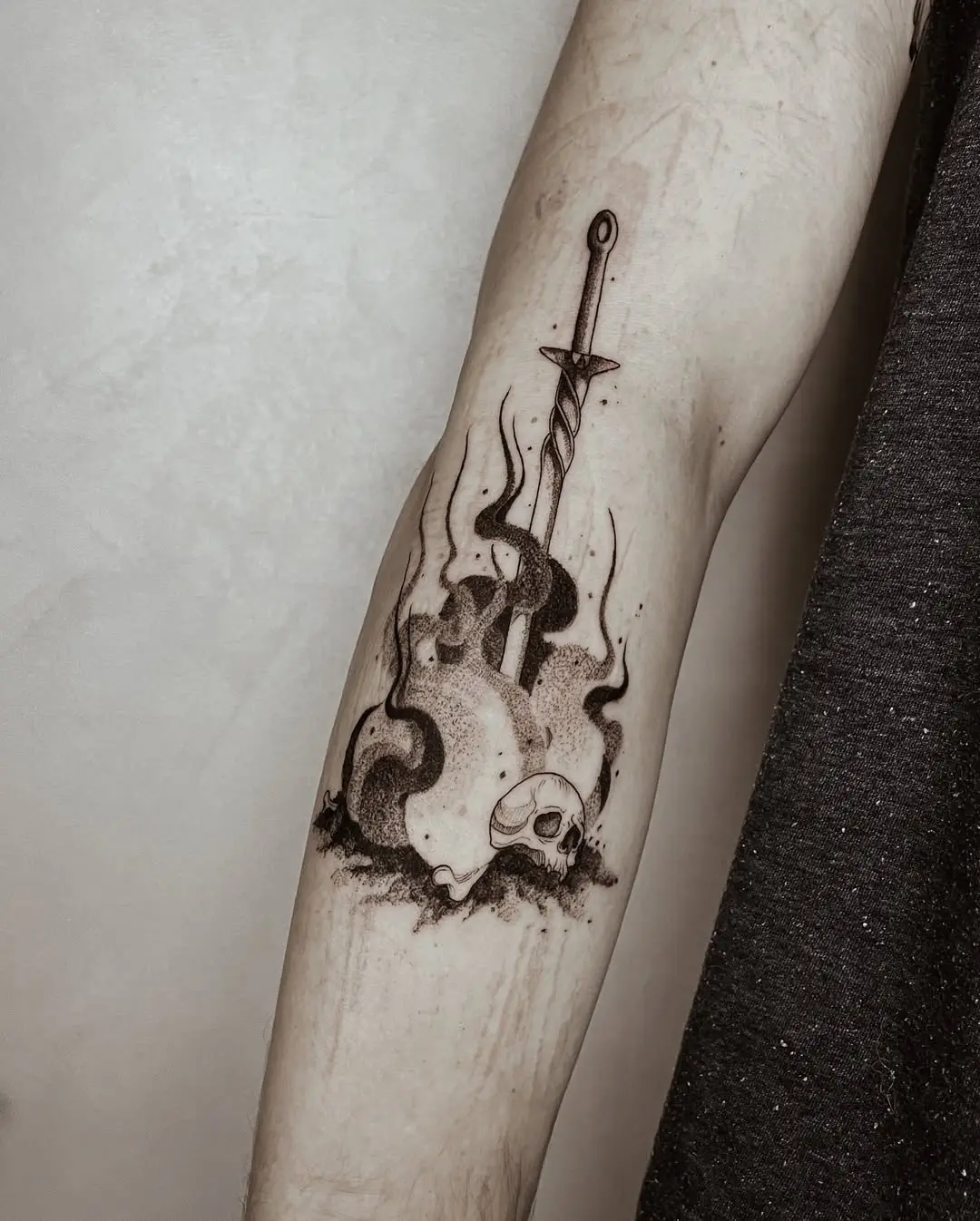 Intricate fire-themed tattoo with sword and skull