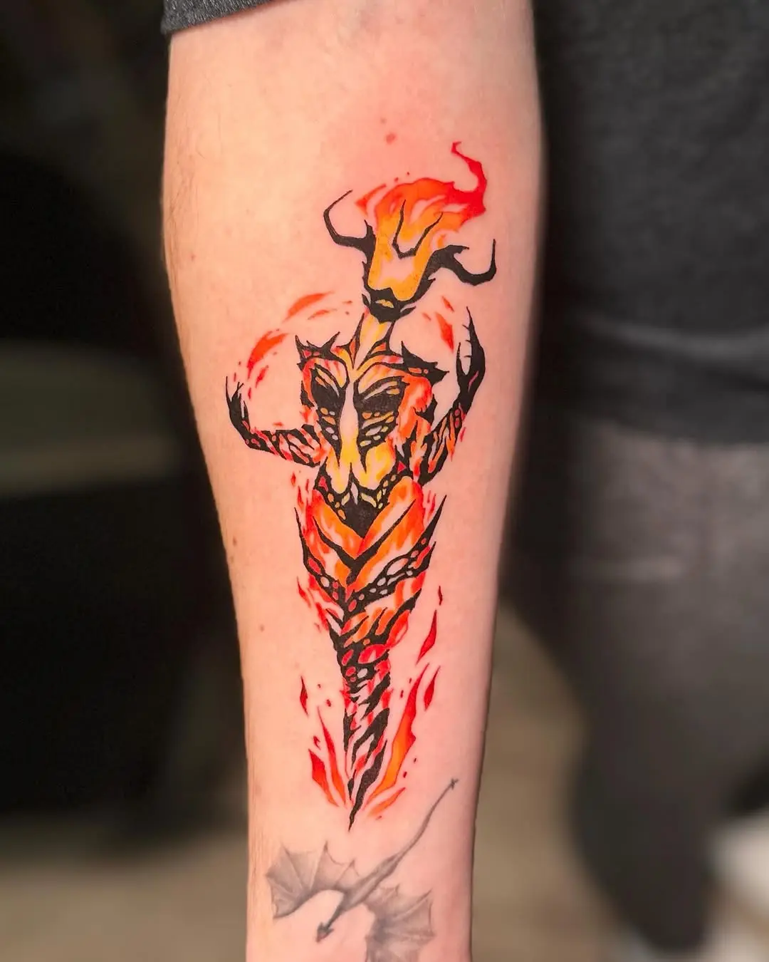 Dynamic fire-themed tattoo showcasing bold colors