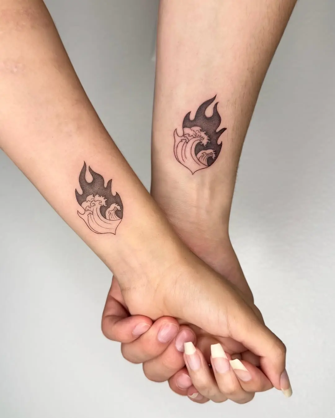 Stylish flame and wave tattoo duo