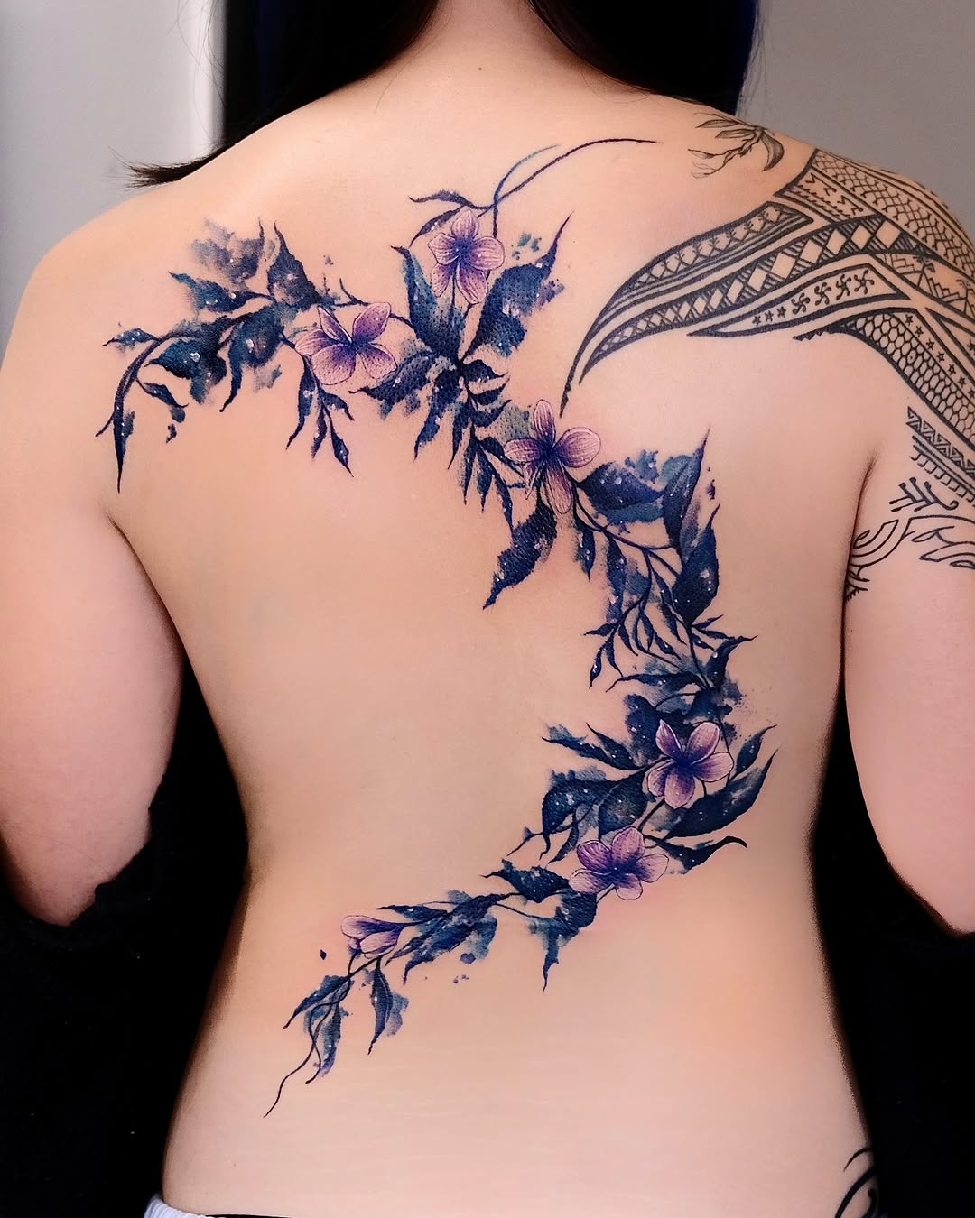 Elegant floral back tattoo design for women